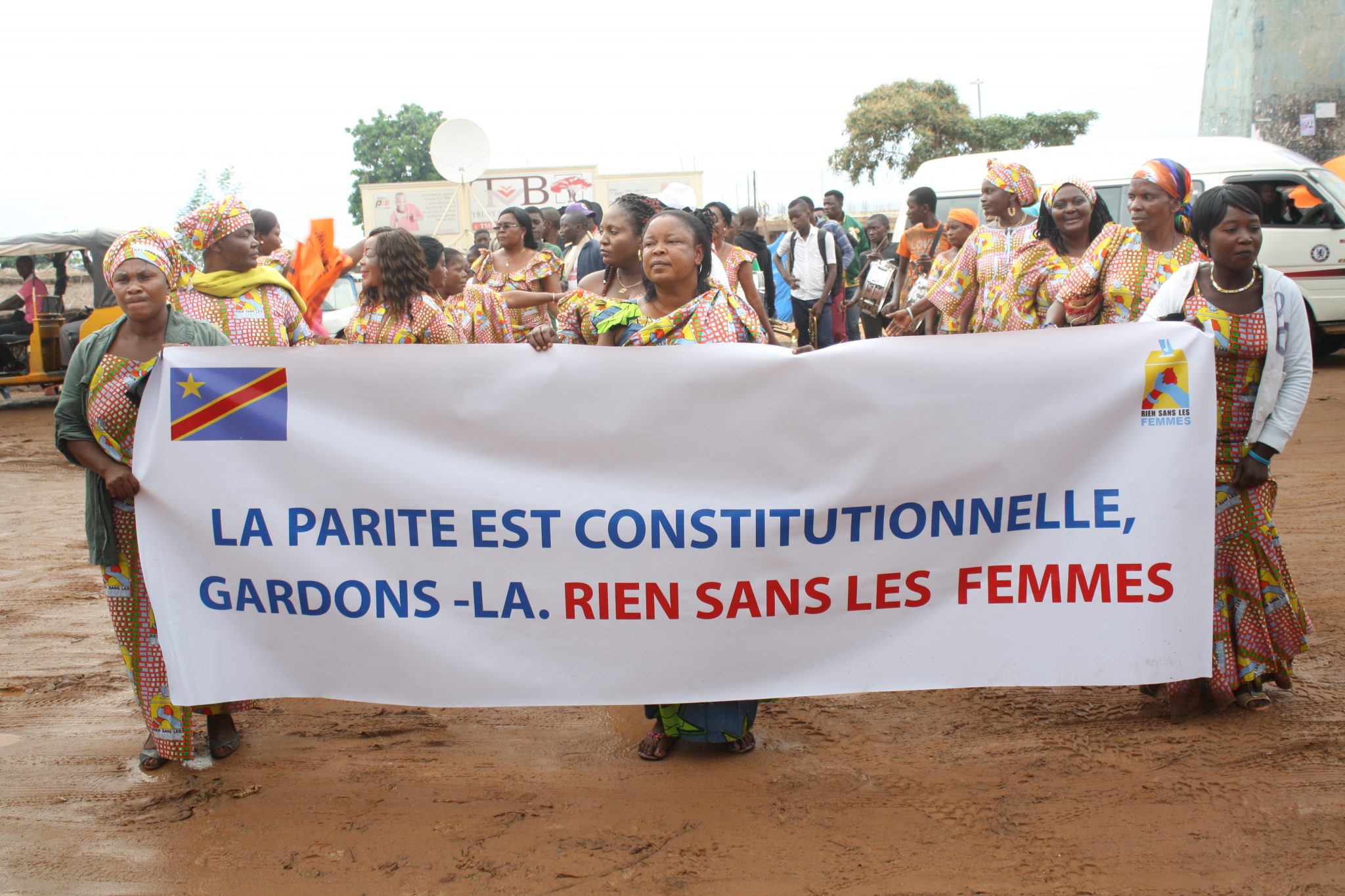 The Rien sans les Femmes movement marching behind a banner saying 