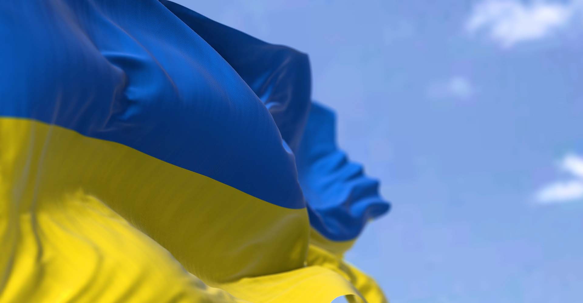 Detail of the national flag of Ukraine waving in the wind. 